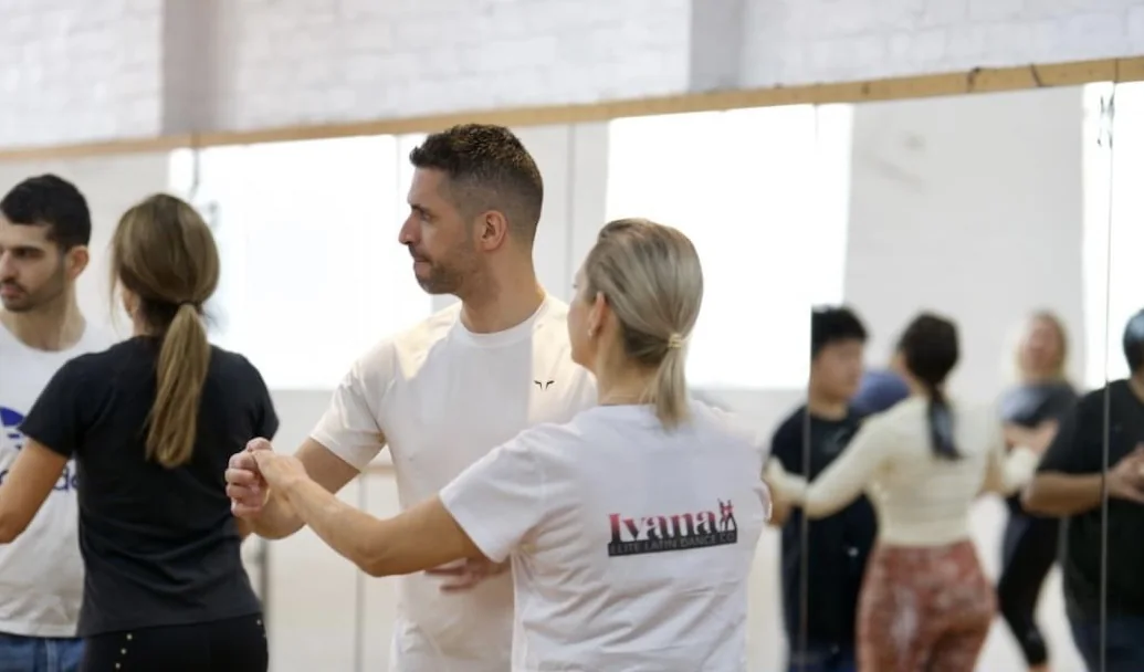 Students practising partnerwork in a Latin dance class