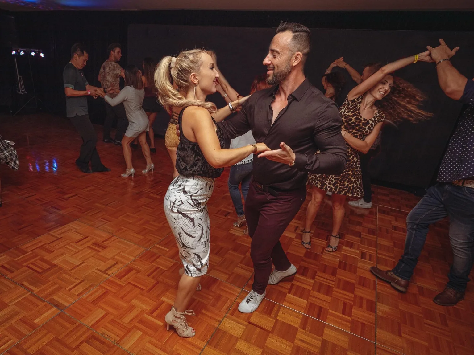 Salsa social dancing with multiple couples on the dance floor