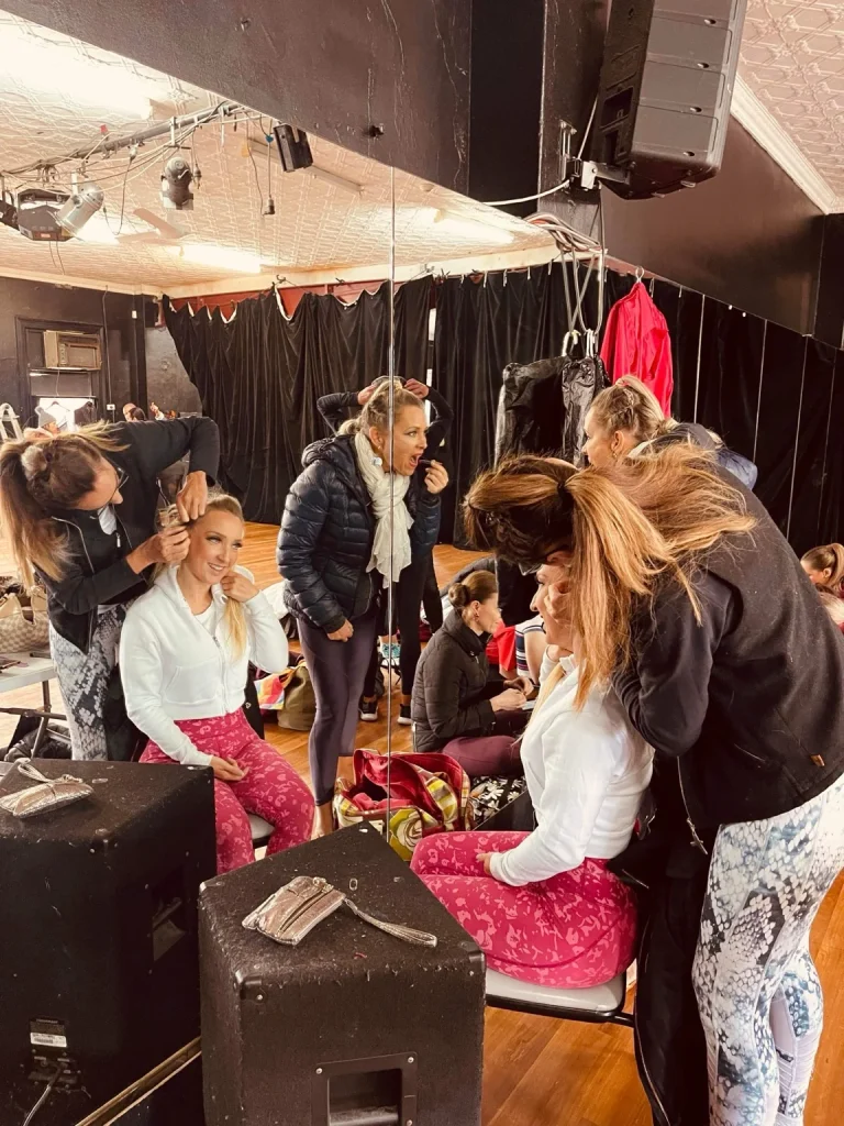 Elite Latin Dance Co. dancers preparing backstage at Rumbia Latin Dance Festival